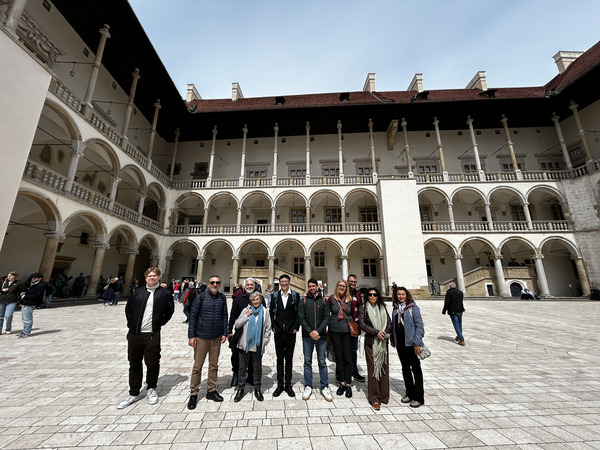 A group of people in front of a building.
