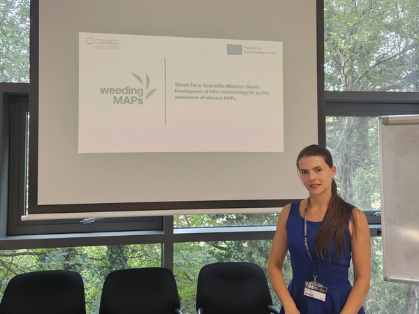Woman standing in front of a projected presentation.