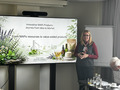 A person presenting in front of a projected slide.