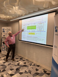 A person points on a projected slide.