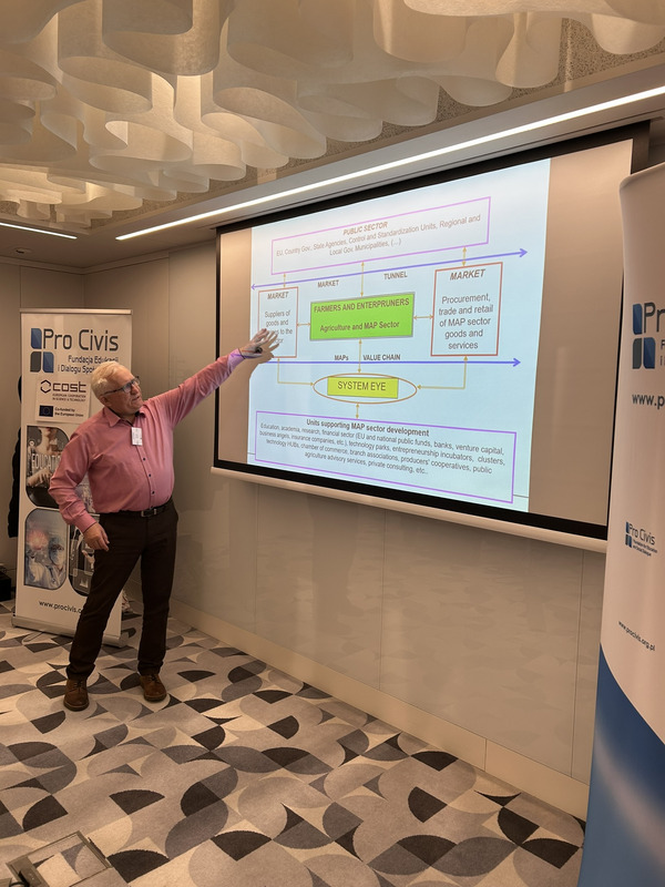 A person points on a projected slide.