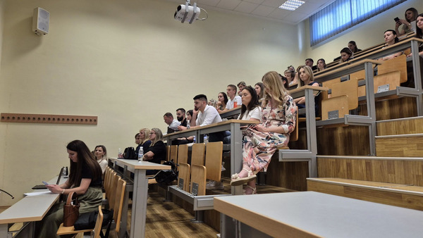 Group of people sitting in a lecture hall.